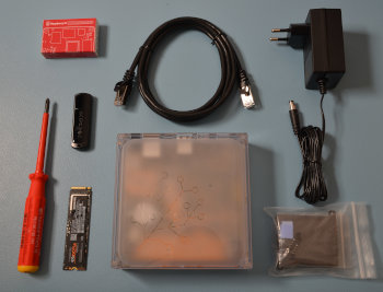 Image showing the Home Assistant Yellow with a Raspberry Pi Compute Module 4, Heat sink assembly bag, Ethernet cable, power supply, a USB flash drive, and an NVMe M.2 SSD drive